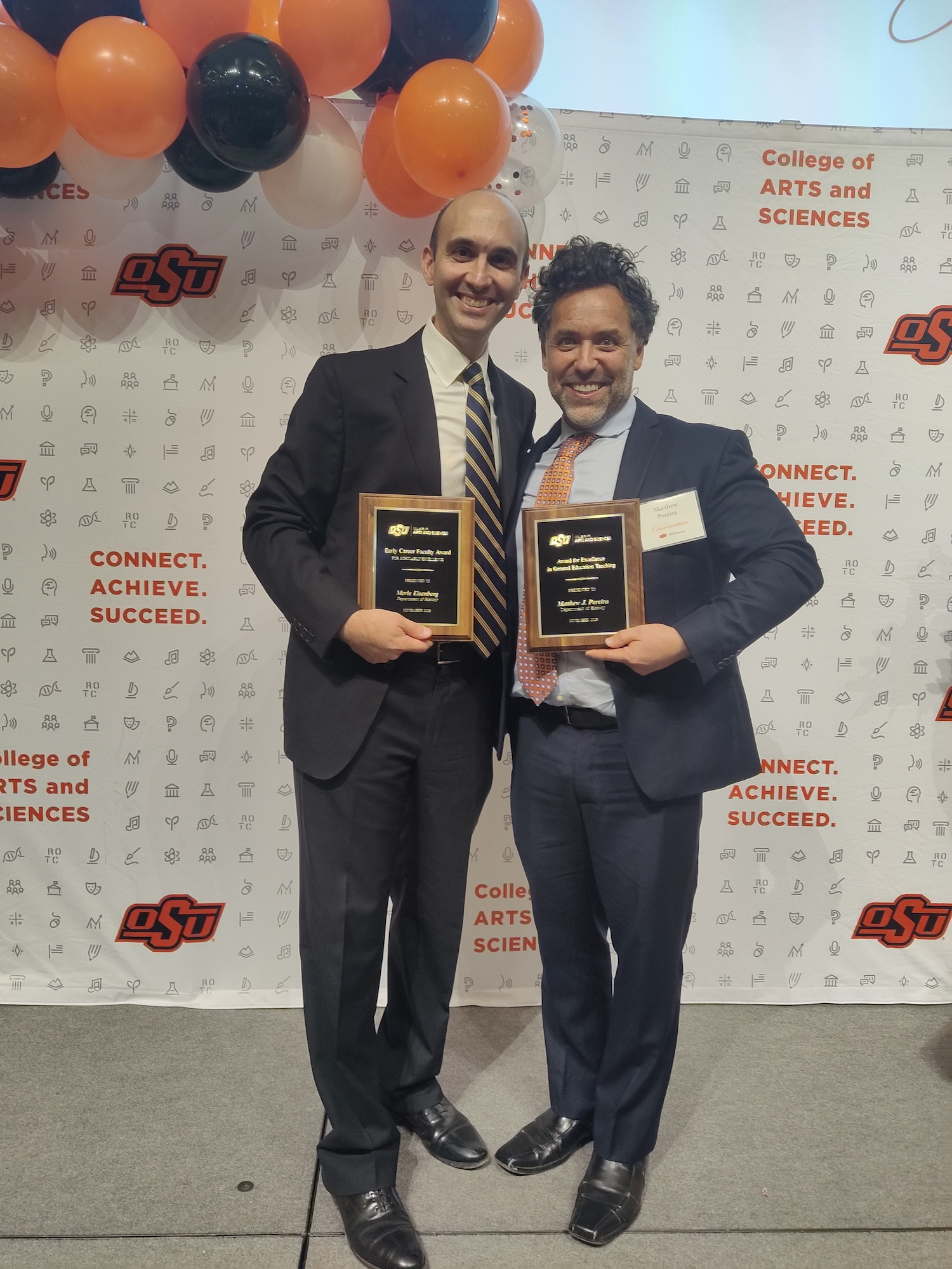 Two men receive awards 