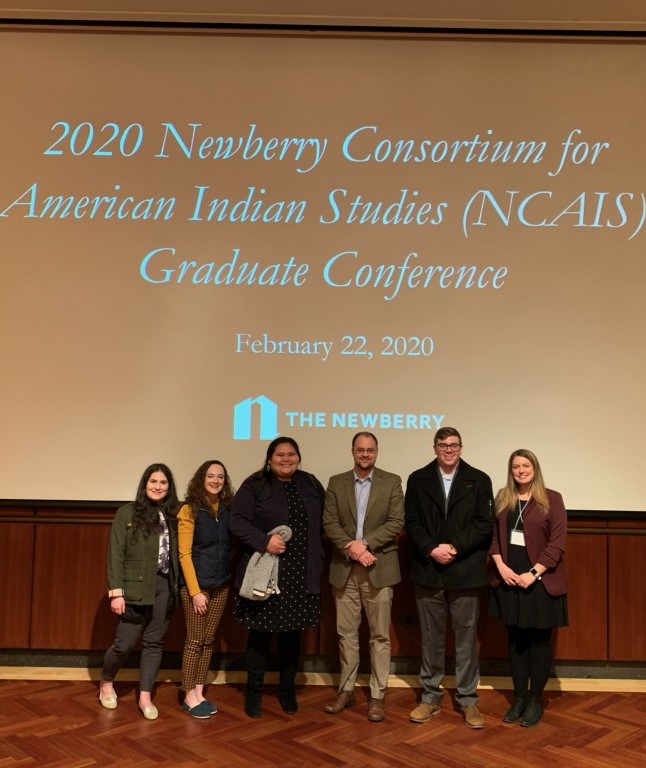 ncaiscrop.jpg Four students and Dr. Boles stand in front of a protector screen with the Newberry logo behing them.