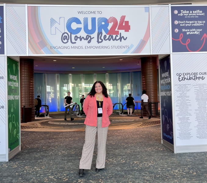 elise braggs standing under a banner