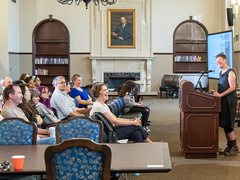 Louise Siddons presenting and smiling at audience Louise Siddons presenting and smiling at audience