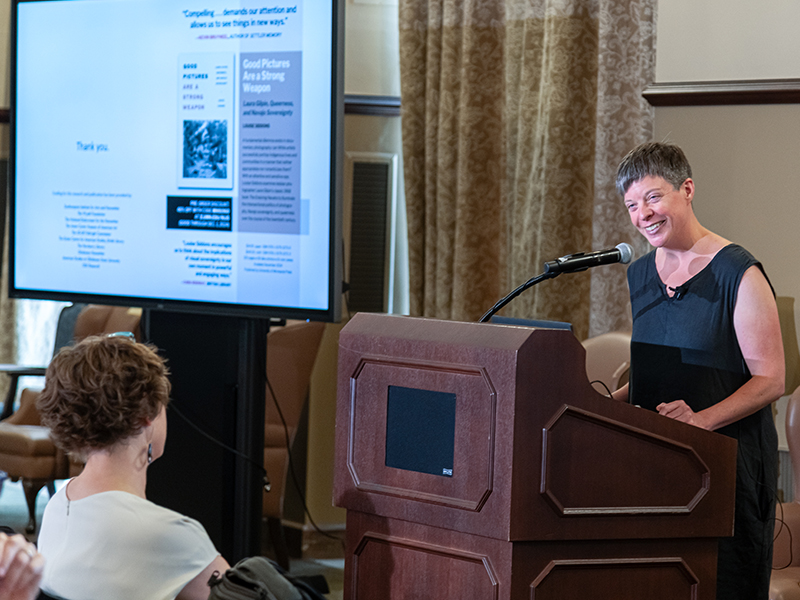 Louise Siddons presenting with a shot of slides Louise Siddons presenting with a shot of slides