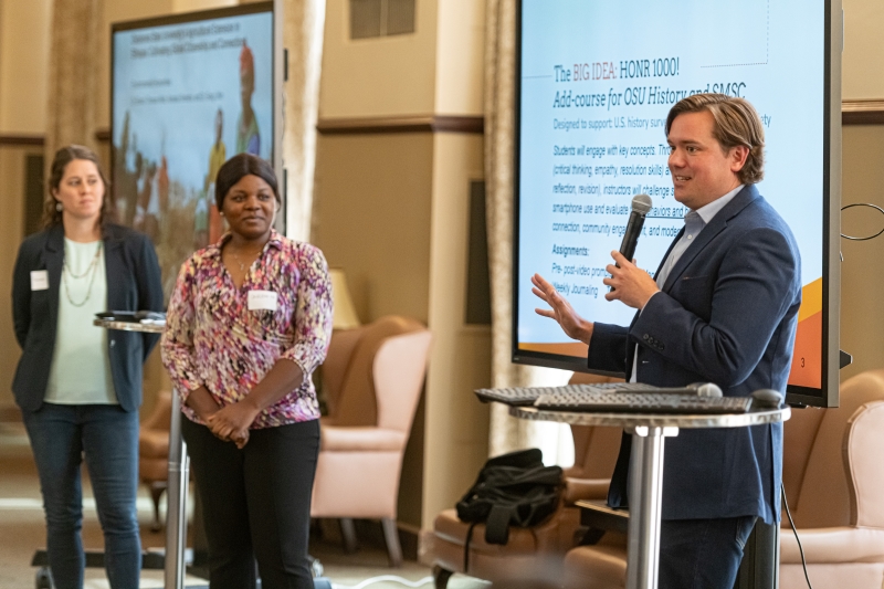 Dr. Andrew Abernathy speaking into a microphone Dr. Andrew Abernathy speaking into a microphone