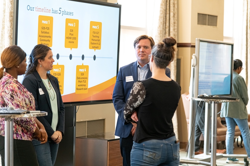 presenters speaking with audience member presenters speaking with audience member