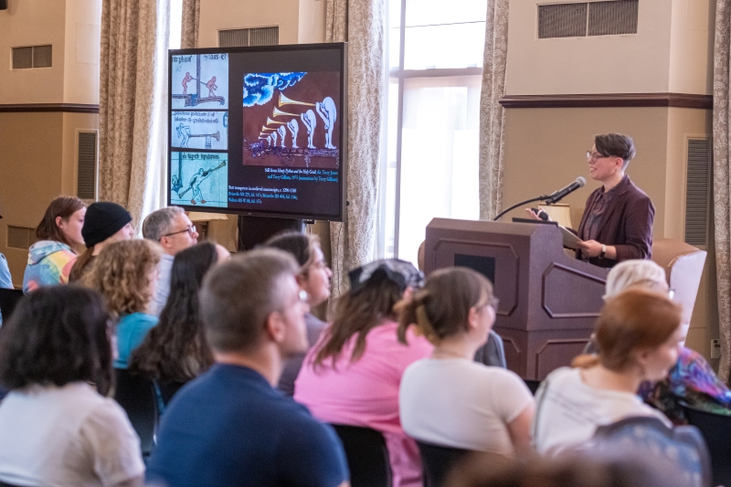 image is of Doyle presenting to the audience image is of Doyle presenting to the audience