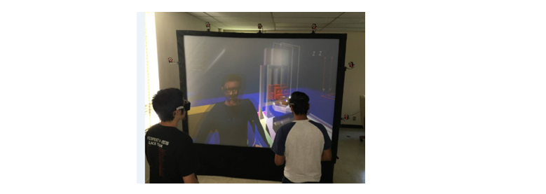 Two of the students (above, seen wearing 3D eye-wear) in the Introduction to Cyber-Physical Systems course seen interacting with an avatar within a 3D VR digital twin environment