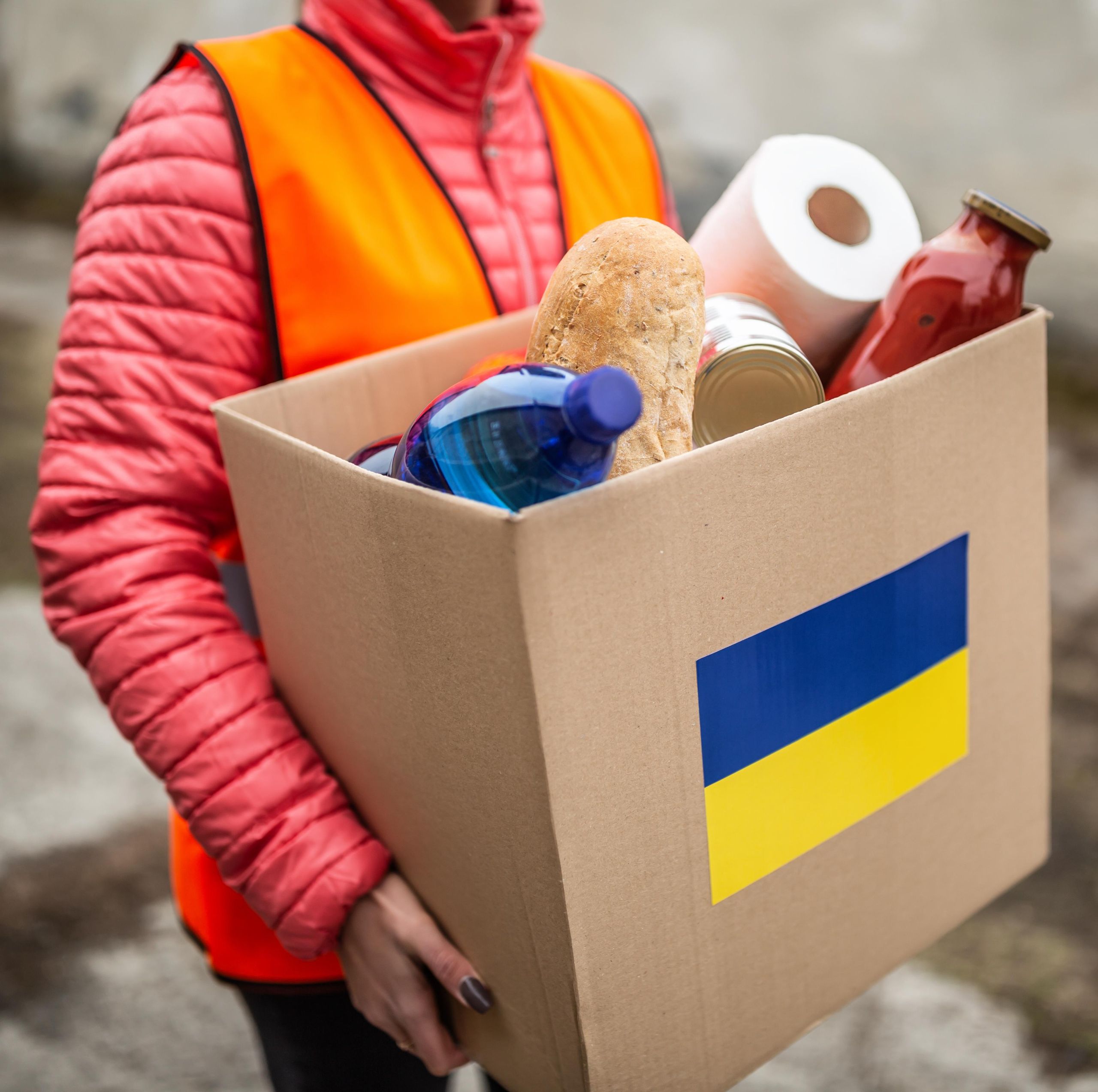person carrying box of groceries person carrying a box of groceries