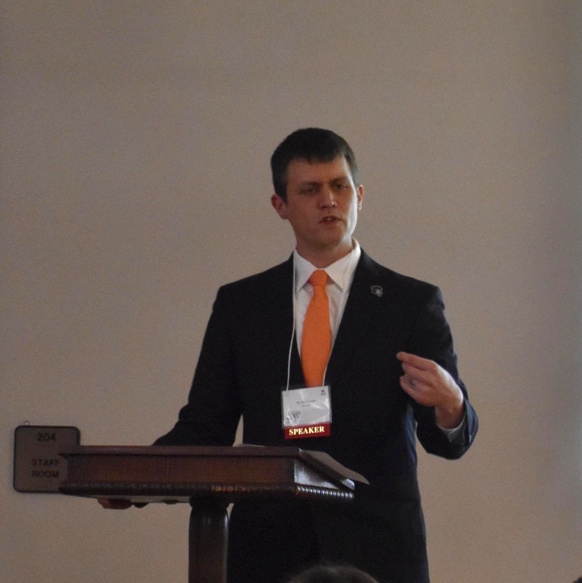 skye cooley at podium speaking. skye cooley at podium speaking.