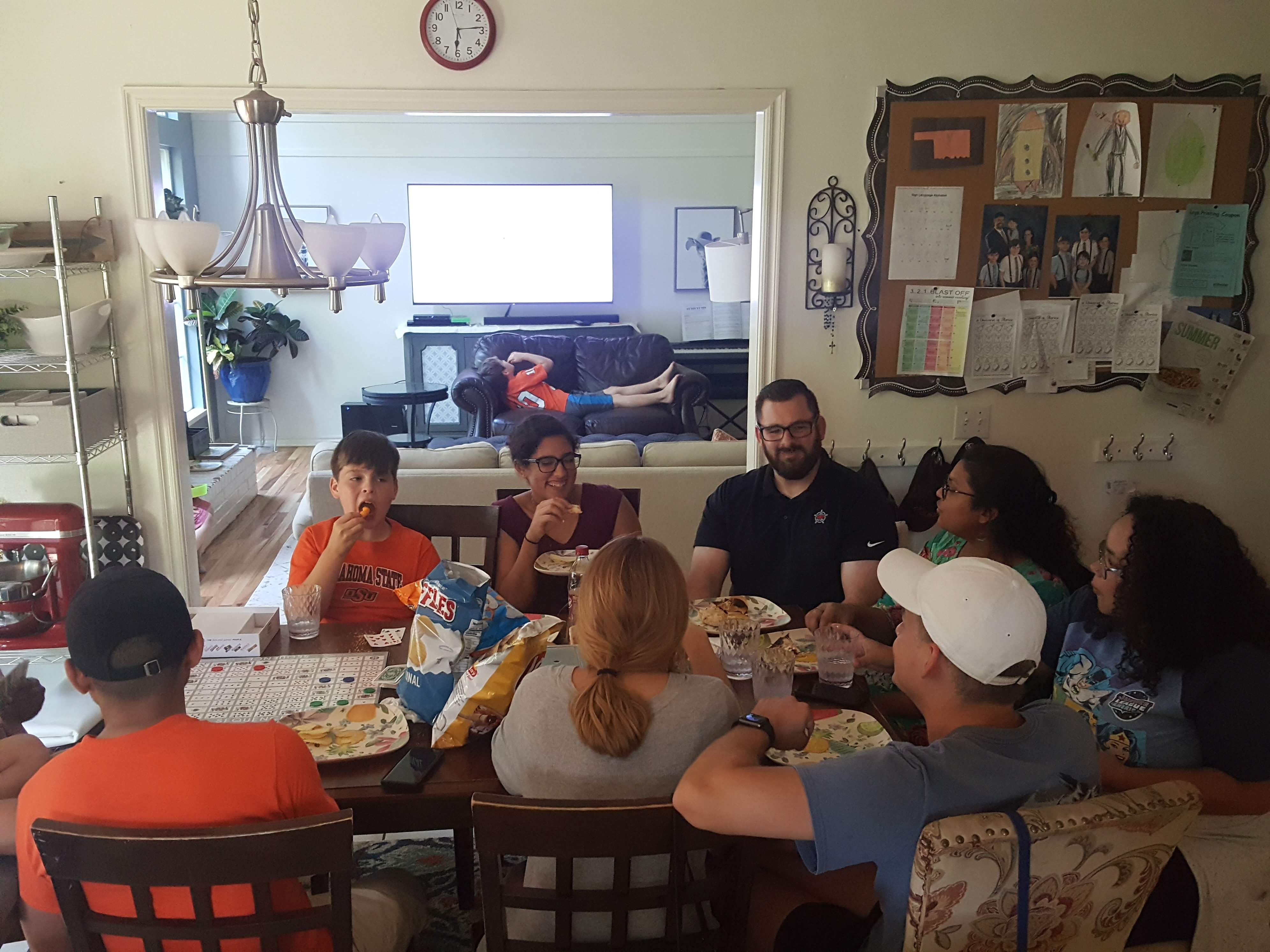 group sitting around a table eating pizza