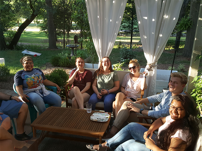 Group of students sitting outside of Dr. Cabeen's house