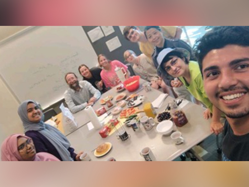 Students sitting around a table in a meeting