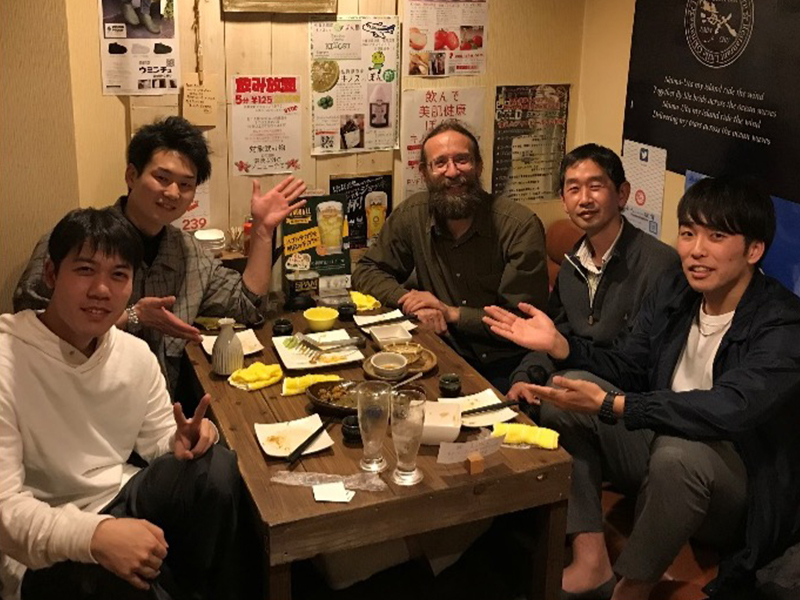Group of men sitting around table