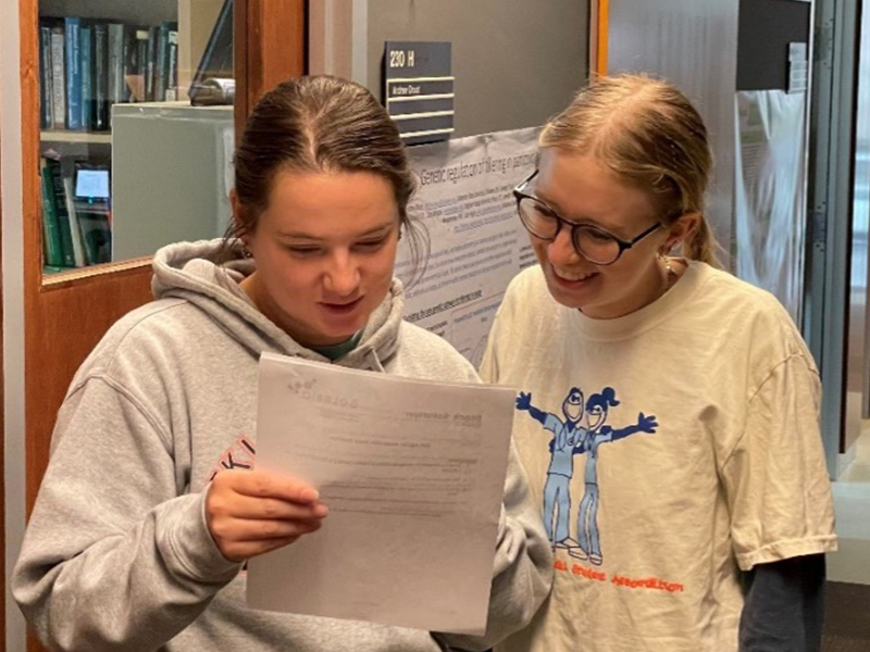 Sarah and Rosalie discussing a paper