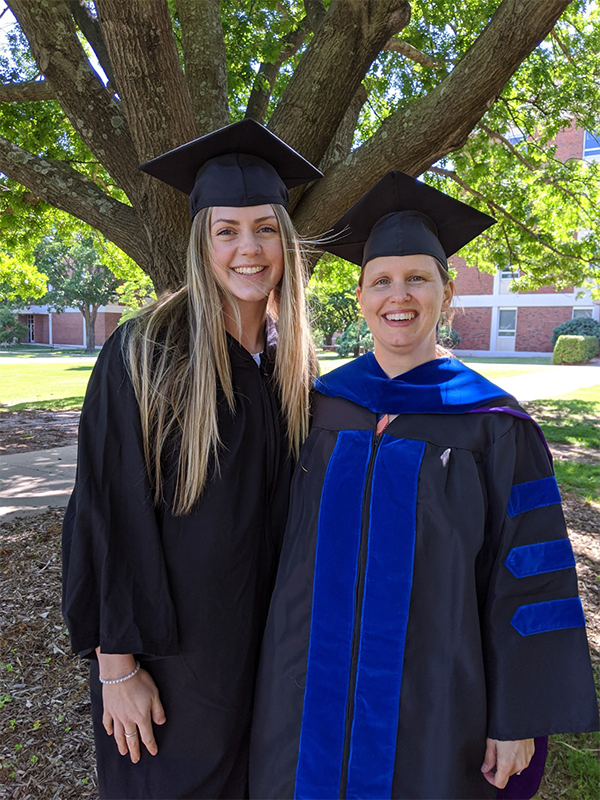 Emma Maritz in graduation attire with Dr. Wozniak