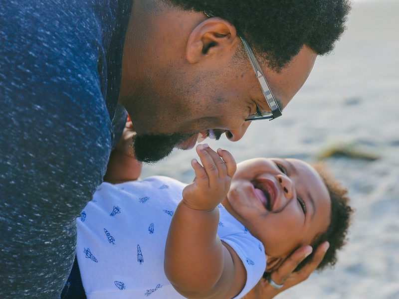 African American father holding his baby