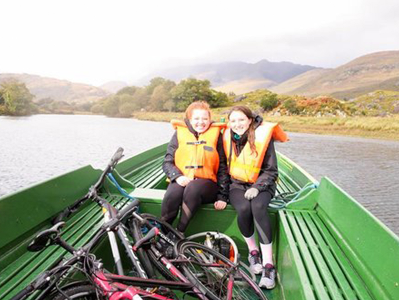 Two females riding in a boat at the International Society of Paediatric Oncology Conference