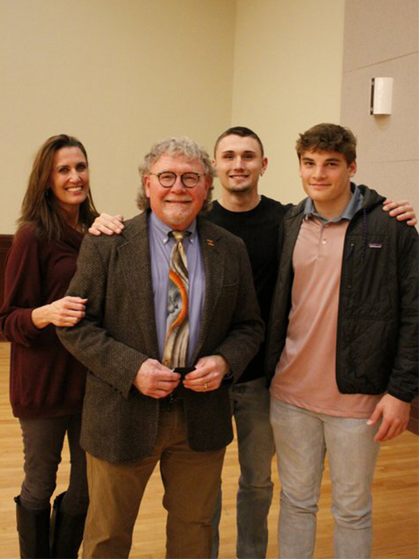 Dr. Mullins and three students smiling at camera
