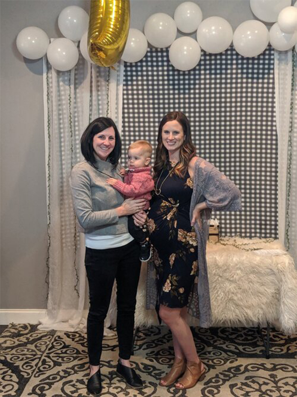 two women and a baby at a baby shower