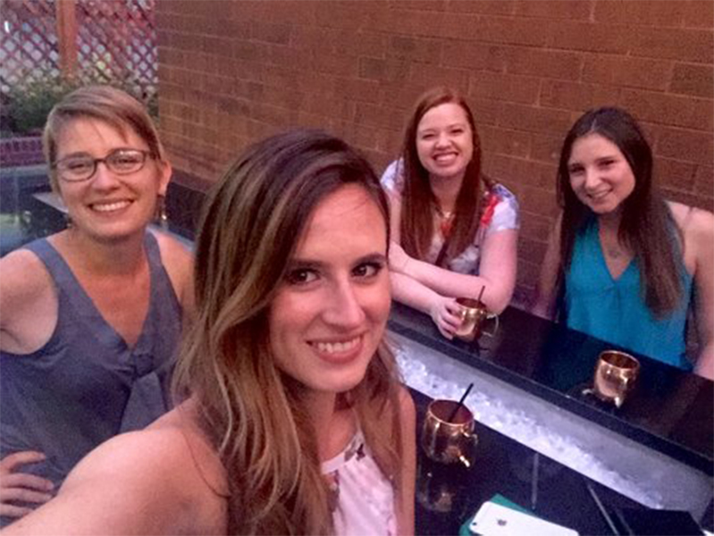 Four female smiling at camera