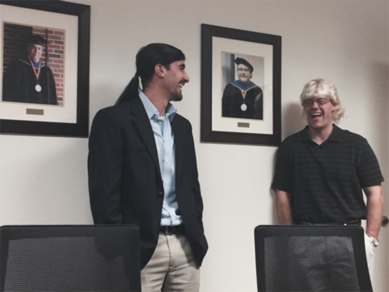 Two male students laughing at each other
