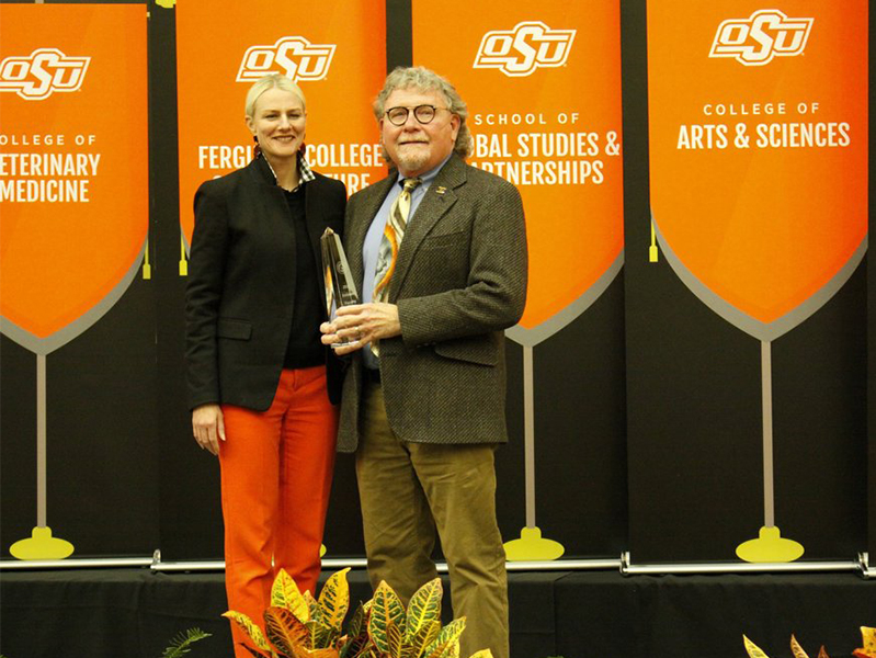 Dr. Mullins with his Eminent Faculty Award 2021 and President Kayse Shrum