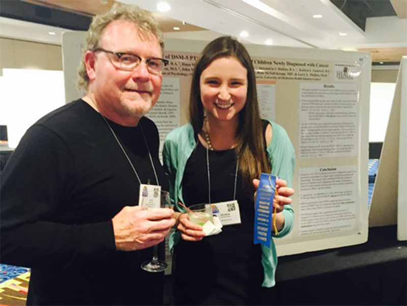 Dr. Mullins and female student in front of poster at Society of Pediatric Psychology Annual Conference