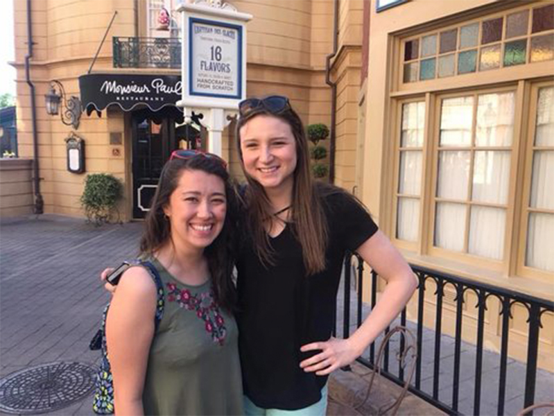 Two female students smiling at the camera