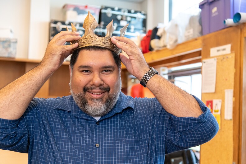 Faculty with a decorative crown held on their head
